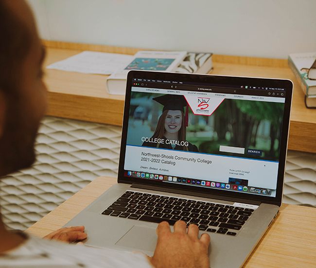 Student using course catalog software on a laptop
